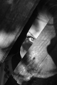 photo of person peeking on wooden floor