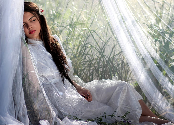 woman in white laying on white textile