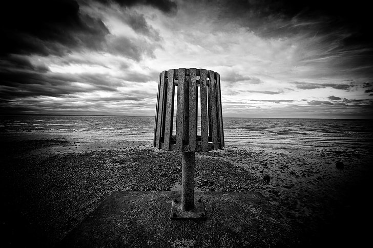 Wide-angle monochrome shot taken at the end of a groin on Whitstable Beach, Kent, England