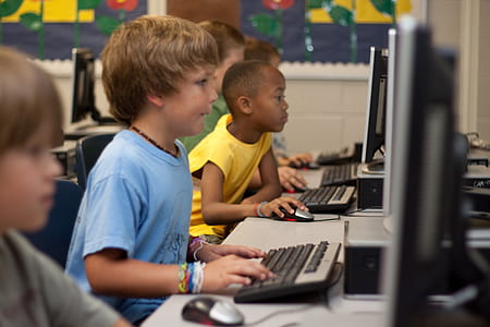 group of boys playing on computers
