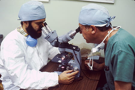 two men looking in microscope
