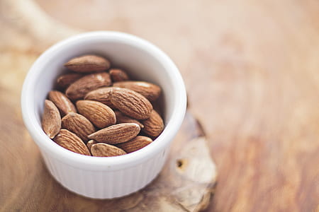 brown almond nuts in round white ramekin
