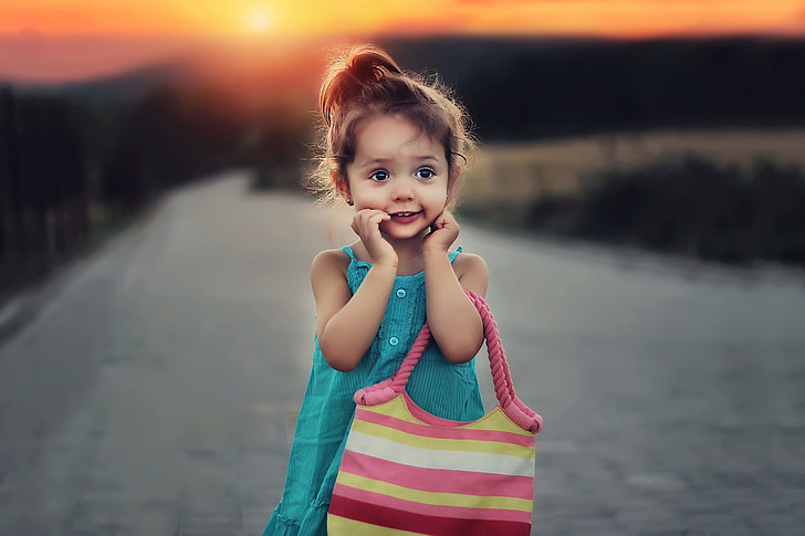 Child with bag at sunset