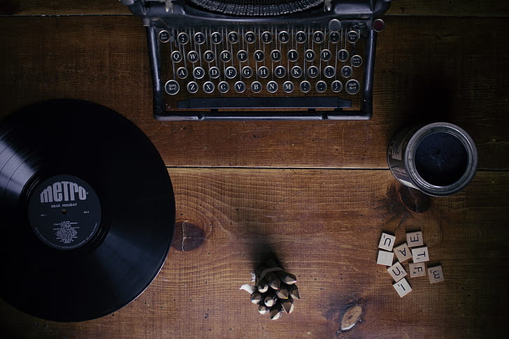 black typewriter on brown wooden top table