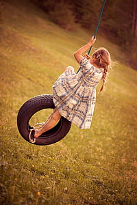 girl riding black rubber tire