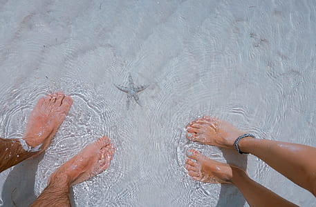 portrait photography of peoples feet on water