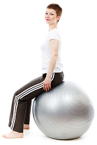 woman in white shirt and black sweat pants sitting on gray stability ball