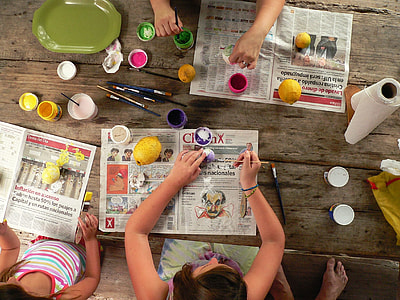 girls painting easter eggs on the table
