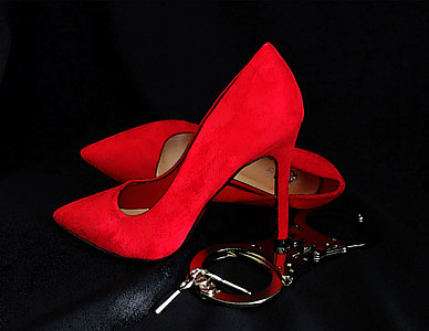 pair of red suede heeled point toe shoes