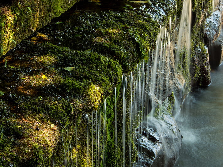 waterfalls near mossy rocks