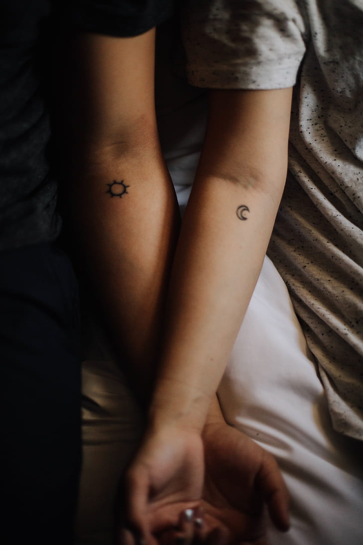 two person with moon and sun tattoo