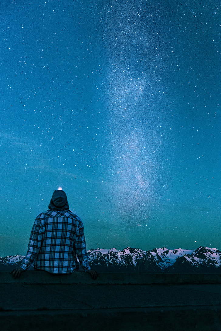 person in blue and black plaid sports shirt watching milkyway