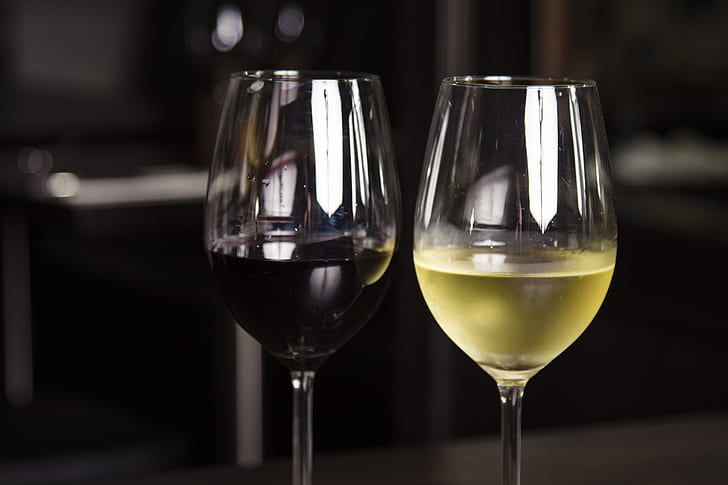 two wine glasses with red and white wine