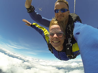 Fisheye Photography of Man and Woman Sky Diving