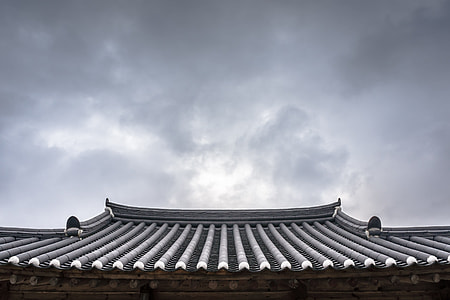 gray roof shingles under cloudy sky during daytime