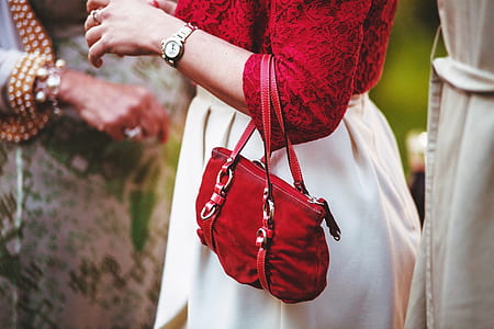 woman in red elbow-sleeved blouse carrying red purse