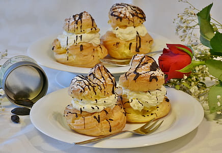 desserts served on white ceramic plate near red rose