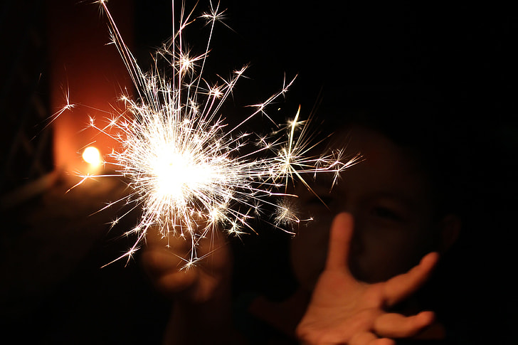 person holding firework during night time