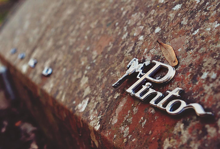 close up shot of chrome Pinto emblem