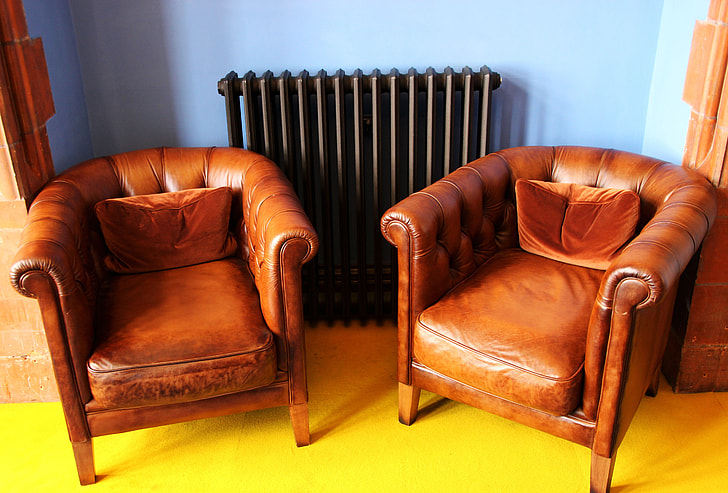 two brown leather armchairs inside the room