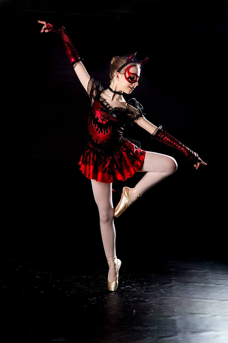 girl wearing black and red dress dancing ballet