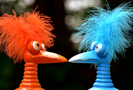 close shot of orange and blue bird plastic toys