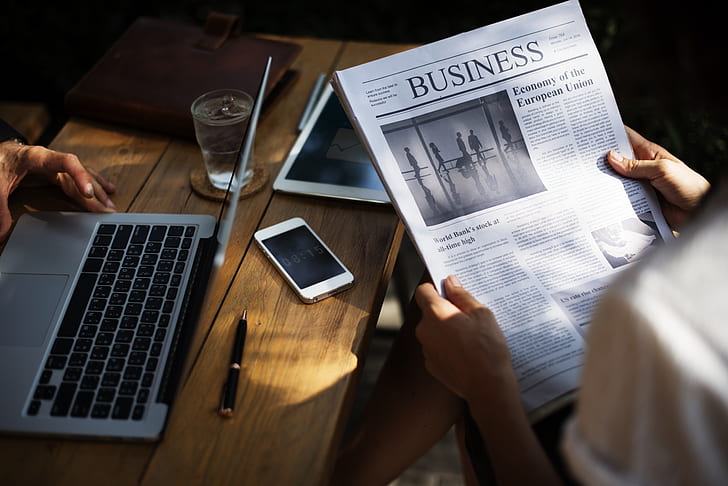 person holding Business newspaper