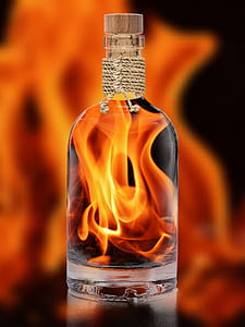 clear glass bottle with fire in side photo