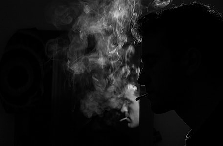 black and white portrait of man smoking