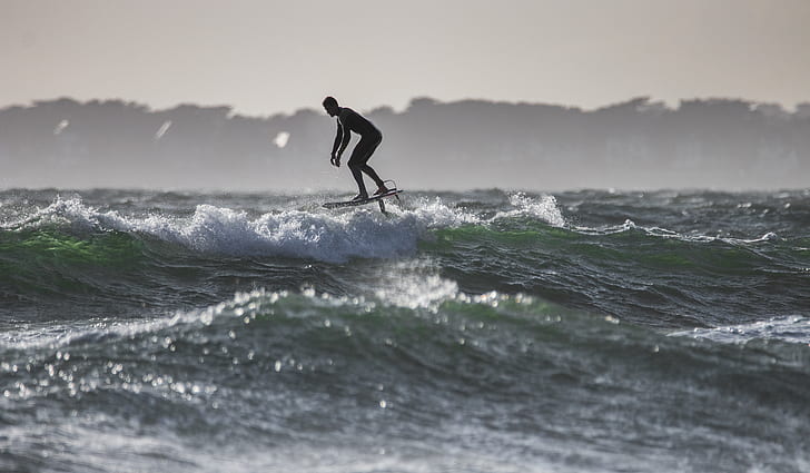 silhouette photo of surfing man