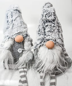 two white-and-grey fur hats