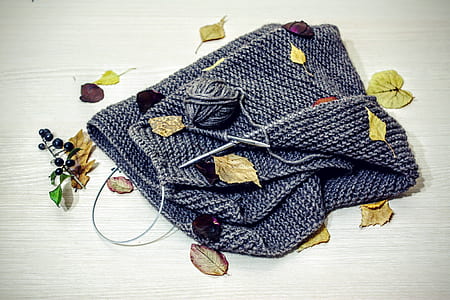 gray knitted bag on brown wooden surface