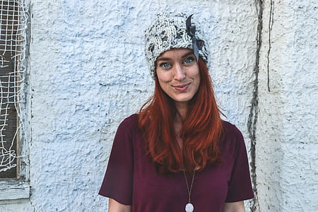 Photo of Woman in Maroon Top and Knitcap