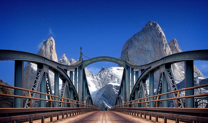 photo of gray metal bridge near mountain