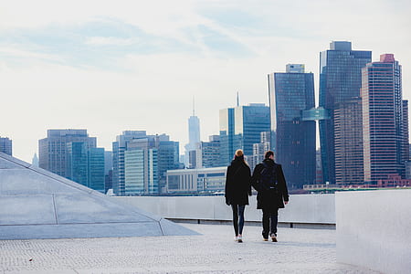 man and woman walking on building