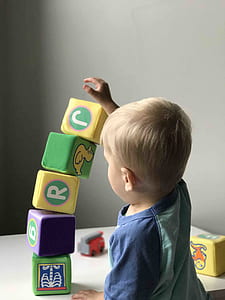 boy holding top of building blocks