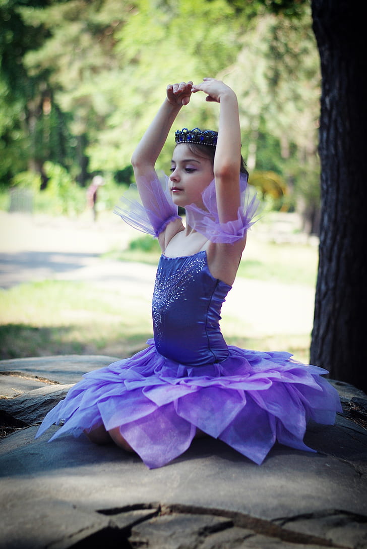 girl wearing purple ballet dress at daytime
