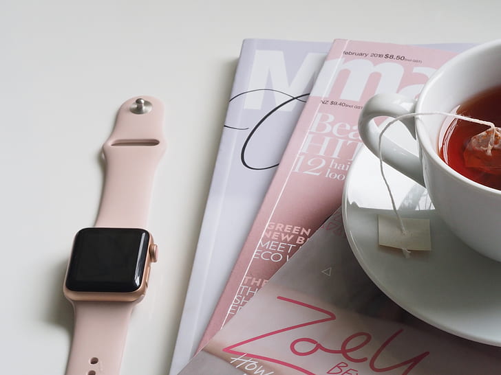 Apple Watch beside white ceramic teacup