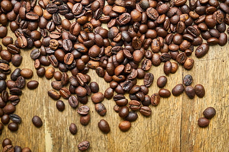 bunch of coffee beans on wooden table