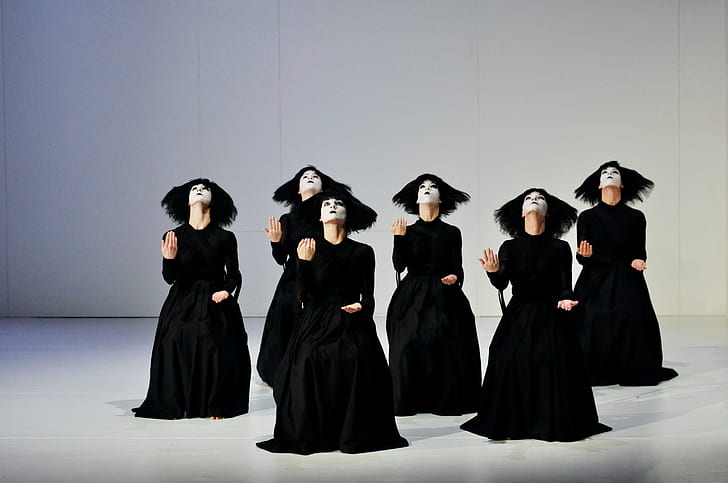women wearing black dress dancing