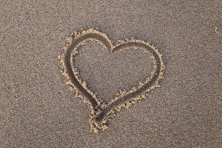 heart shape in sand at daytime