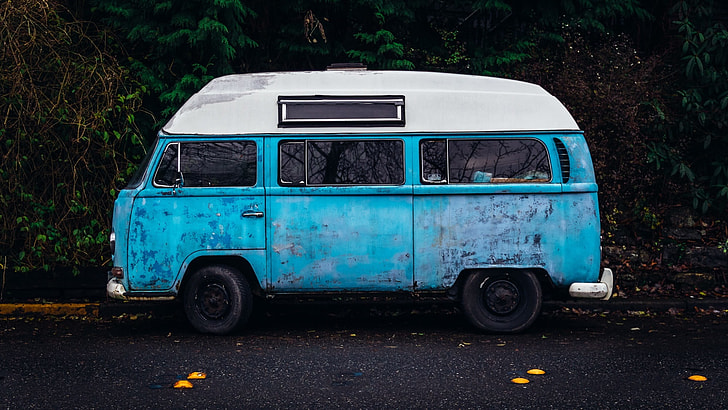 photography of vintage blue van on street