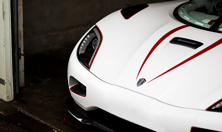 white Koenigsegg parked inside garage