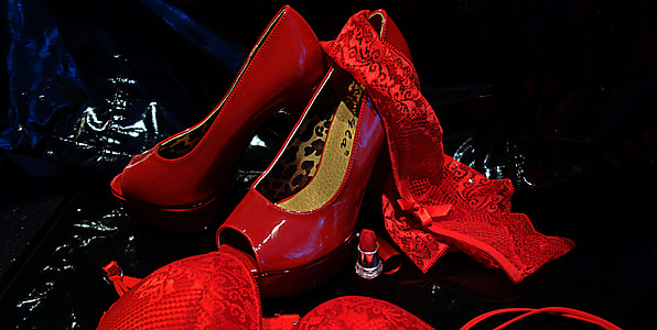 pair of red peep-toe patent leather heeled shoes beside laced underwear