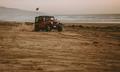 red Jeep Wrangler on beach