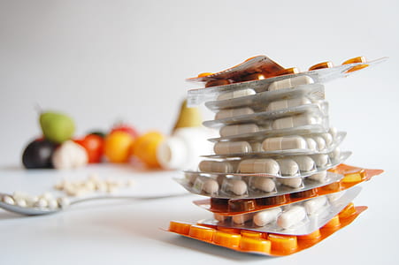 white and orange medicine blister packs stacked