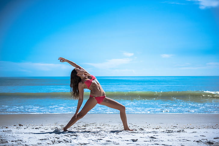 Royalty-Free photo: Photo of woman doing yoga on the beach