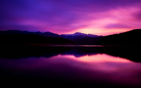 landscape photography of lake under purple sky during daytime