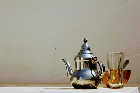 gray stainless steel kettle near clear drinking glass