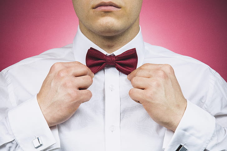 man holding red bow tie